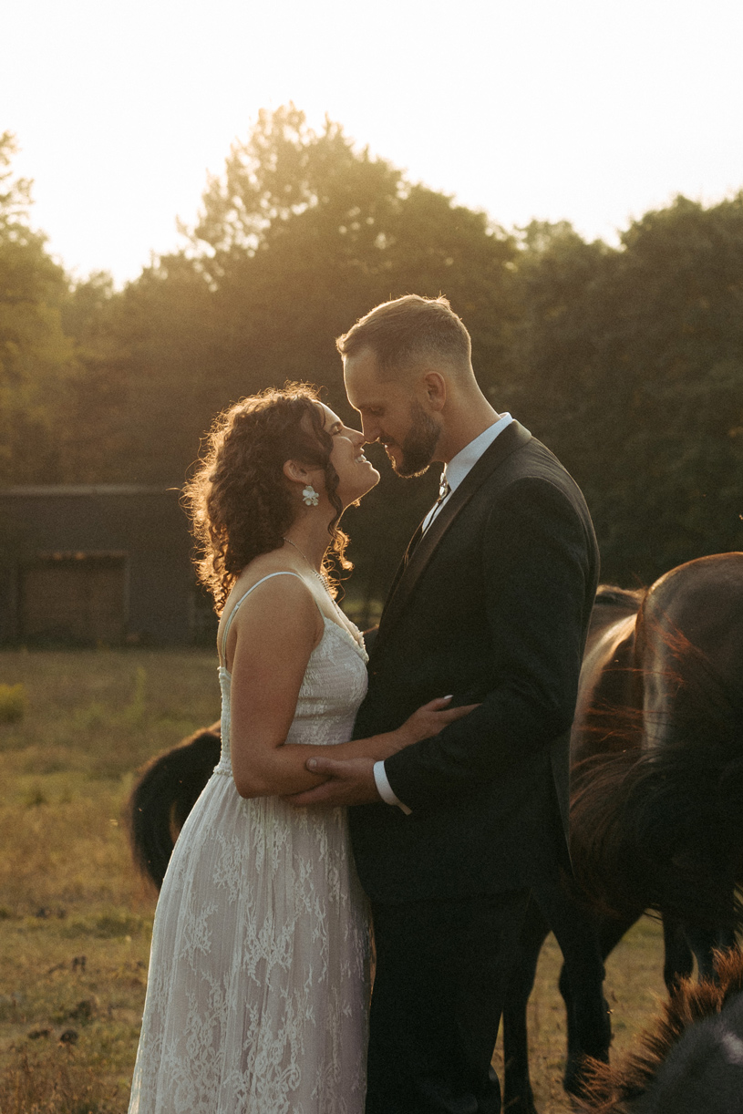 Courtney and John sharing a quiet moment surrounded by horses and ponies on their family farm.
