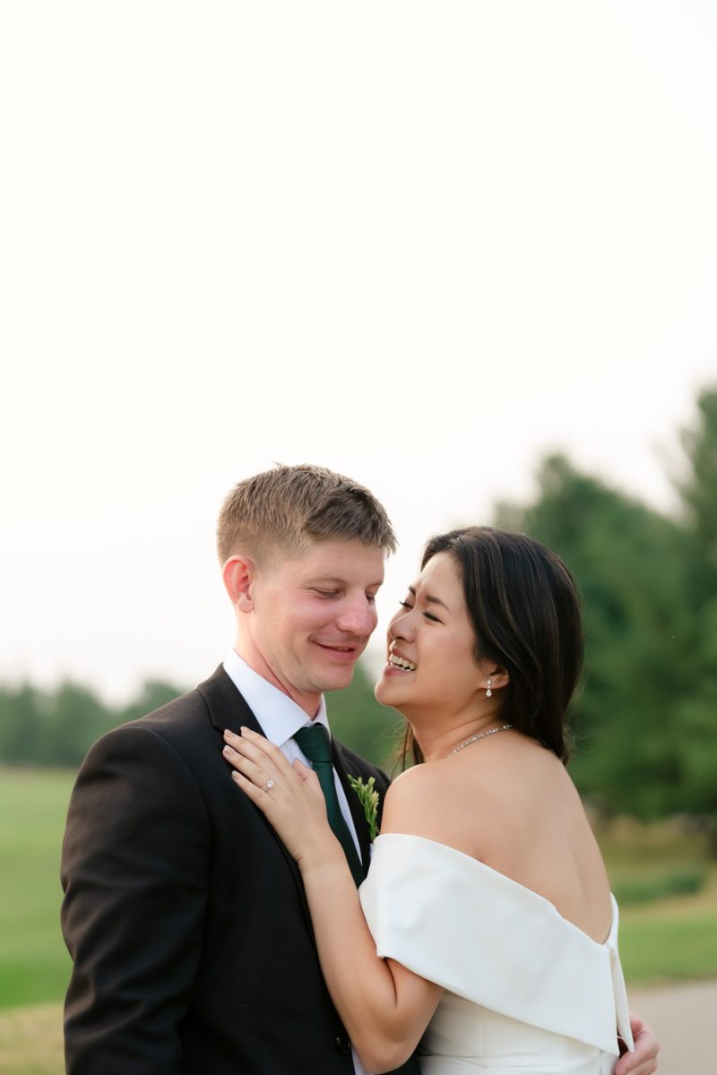 Anita and Scott holding hands during their outdoor ceremony at Cope Town Wood Golf Course Toronto wedding photographer